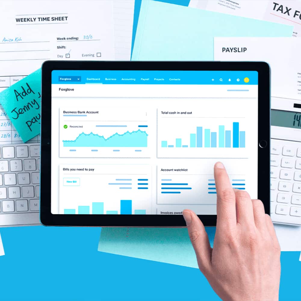The Xero dashboard open on an iPad on top of a pile of paper documents.