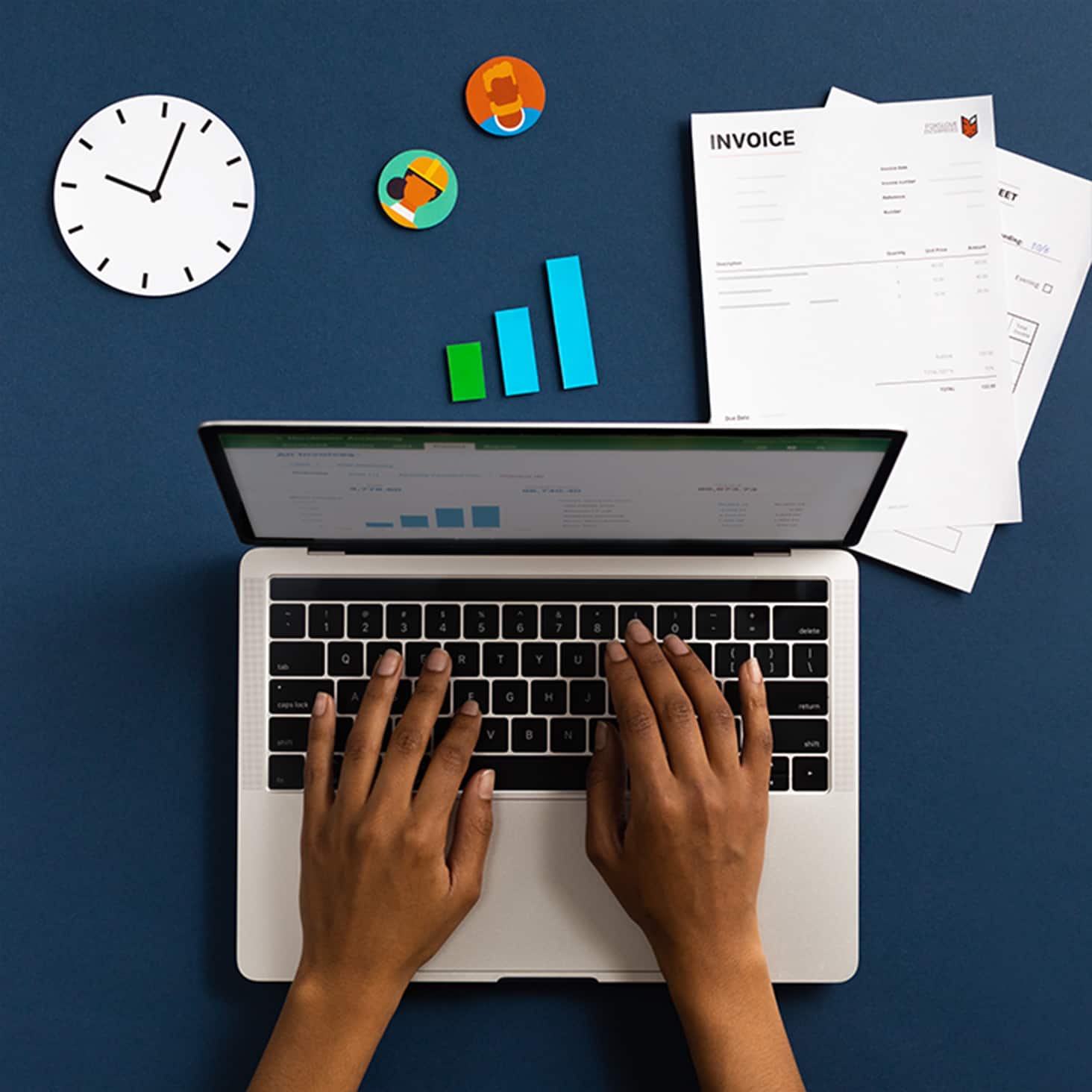 A bookkeeper works at a laptop, getting a client’s account up to date ready